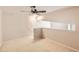 Bright bedroom with carpet flooring and a staircase to another level at 9481 E Mansfield Ave # 305, Aurora, CO 80014