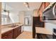 Kitchen features stone countertops, stainless steel appliances, and a view of the living spaces at 9481 E Mansfield Ave # 305, Aurora, CO 80014