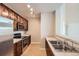 Well-lit kitchen features stainless steel appliances, stone countertops, and wood cabinetry at 9481 E Mansfield Ave # 305, Aurora, CO 80014