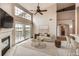 Bright living room featuring a fireplace, plush rug, and balcony access with sliding glass doors at 9481 E Mansfield Ave # 305, Aurora, CO 80014