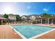 Community pool with lounging chairs and pergola at 9481 E Mansfield Ave # 305, Aurora, CO 80014