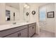 Double sink bathroom with quartz countertops, gray cabinets, and modern lighting at 16135 Mountain Flax Dr, Monument, CO 80132
