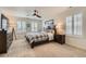 Cozy bedroom with a plaid comforter, dark wood furnishings, and plantation shutters at 16135 Mountain Flax Dr, Monument, CO 80132