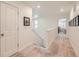 Bright hallway with carpeted floor, white walls, and natural light. A picture hangs above an outlet at 16135 Mountain Flax Dr, Monument, CO 80132