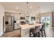 Bright kitchen featuring an island with bar seating, stainless steel appliances, and modern lighting at 16135 Mountain Flax Dr, Monument, CO 80132