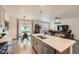 Open-concept kitchen with an island, stainless steel appliances, and views of the living area at 16135 Mountain Flax Dr, Monument, CO 80132