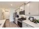 Modern kitchen with stainless steel appliances, white countertops, and grey cabinets at 16135 Mountain Flax Dr, Monument, CO 80132