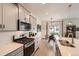 Contemporary kitchen with stainless appliances, subway tile, and a dining area at 16135 Mountain Flax Dr, Monument, CO 80132