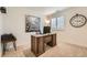 Bright office space featuring a wood desk, chair, and ample natural light from a nearby window with shutters at 16135 Mountain Flax Dr, Monument, CO 80132