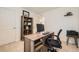 A carpeted office space with light walls features a wood desk, a computer, and a wooden bookshelf in the corner at 16135 Mountain Flax Dr, Monument, CO 80132