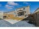 Backyard view with a patio, fenced yard, and partial snow cover; great for outdoor enjoyment at 27882 E 9Th Dr, Aurora, CO 80018