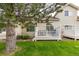 Backyard view showcasing a well-manicured lawn and inviting outdoor patio spaces at 13545 W 62Nd Ln, Arvada, CO 80004