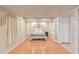 Basement featuring a large living space, wood floors, and neutral-colored walls and curtains at 13545 W 62Nd Ln, Arvada, CO 80004