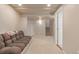 Large carpeted basement with access to the stairs, storage, and a neutral color scheme at 13545 W 62Nd Ln, Arvada, CO 80004