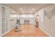 View of basement exercise space with wood floors, large mirror and storage cabinetry at 13545 W 62Nd Ln, Arvada, CO 80004