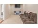 Basement living room area with comfortable seating, television and storage at 13545 W 62Nd Ln, Arvada, CO 80004