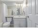 Bathroom featuring a toilet and vanity with a large mirror above at 13545 W 62Nd Ln, Arvada, CO 80004