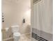 Cozy bathroom with toilet, sink and tiled shower with striped curtain at 13545 W 62Nd Ln, Arvada, CO 80004