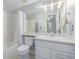 Bathroom featuring a toilet and vanity with a large mirror above at 13545 W 62Nd Ln, Arvada, CO 80004