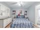 Clean bedroom features wood floors, white walls, ceiling fan, and sports themed decoration at 13545 W 62Nd Ln, Arvada, CO 80004