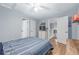 Bedroom featuring wood floors, white walls, ceiling fan, and two closets at 13545 W 62Nd Ln, Arvada, CO 80004