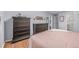 Well-lit bedroom with ample storage provided by the matching dresser and chest at 13545 W 62Nd Ln, Arvada, CO 80004