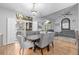 Elegant dining area with a large window, modern lighting, and comfortable seating for entertaining guests at 13545 W 62Nd Ln, Arvada, CO 80004