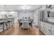 Charming dining area with hardwood floors and elegant lighting, open to the kitchen and living spaces at 13545 W 62Nd Ln, Arvada, CO 80004