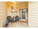 Inviting covered porch with chairs and a welcome mat, perfect for enjoying the outdoors at 13545 W 62Nd Ln, Arvada, CO 80004