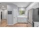 Bright kitchen with stainless steel appliances, white cabinetry, and hardwood floors at 13545 W 62Nd Ln, Arvada, CO 80004