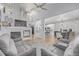 Open-concept living room with fireplace, hardwood floors, and a view to the dining area and kitchen at 13545 W 62Nd Ln, Arvada, CO 80004