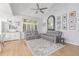 Spacious living room with hardwood floors, large window, and comfortable seating arrangement with a modern ceiling fan at 13545 W 62Nd Ln, Arvada, CO 80004
