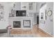 Open-concept living area with a fireplace and view to staircase and front door at 13545 W 62Nd Ln, Arvada, CO 80004