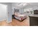 This bedroom features wood floors, light gray walls, a ceiling fan, and a bed with decorative pillows and bedding at 13545 W 62Nd Ln, Arvada, CO 80004