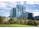 Modern glass-faced high rise condominium building with blue skies and green landscape at 1700 Bassett St # 609, Denver, CO 80202
