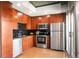 Well-lit kitchen with hardwood floors, stainless steel appliances, and dark wood cabinetry at 1700 Bassett St # 609, Denver, CO 80202