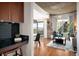 Modern living room featuring a chic wet bar, hardwood floors, and access to a private balcony at 1700 Bassett St # 609, Denver, CO 80202