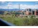 Expansive view of the park, bridge and city skyline with mountains in the background at 1700 Bassett St # 609, Denver, CO 80202