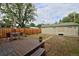 Spacious backyard featuring a deck with seating, a manicured lawn, and detached garage at 482 S Logan St, Denver, CO 80209