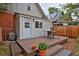 Exterior deck area with table and chairs, beautiful landscaping, and view of the home's architectural details at 482 S Logan St, Denver, CO 80209
