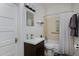A charming bathroom features tiled walls, a new toilet, and bright lighting above the vanity at 482 S Logan St, Denver, CO 80209