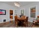 Charming dining room with a modern chandelier, hardwood floors, and windows at 482 S Logan St, Denver, CO 80209