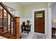 Welcoming foyer with hardwood floors and a staircase with wooden banister at 482 S Logan St, Denver, CO 80209