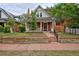 Charming brick home with a welcoming front porch and well-maintained landscaping at 482 S Logan St, Denver, CO 80209