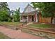 Charming brick home with a welcoming front porch and well-maintained landscaping at 482 S Logan St, Denver, CO 80209