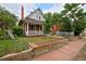 Charming brick home with a welcoming front porch and well-maintained landscaping at 482 S Logan St, Denver, CO 80209