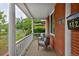 Inviting front porch with brick accents, white columns, and a cozy seating area at 482 S Logan St, Denver, CO 80209