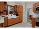 Beautiful kitchen with wood cabinets, farmhouse sink, and access to the dining room at 482 S Logan St, Denver, CO 80209