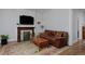 Cozy living room with a stone fireplace, hardwood floors, and a comfortable sofa at 482 S Logan St, Denver, CO 80209