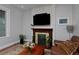 Cozy living room with a stone fireplace, hardwood floors, and a comfortable sofa at 482 S Logan St, Denver, CO 80209